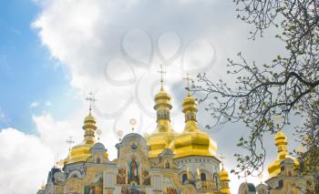 Kiev-Pecherskaya Laura in spring. Golden domes over cloudy sky
