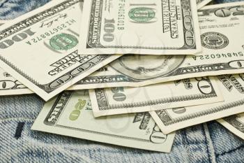 Wealth and freedom - US dollar banknotes and jeans