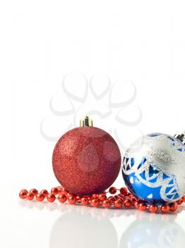 Christmas greetings - colorful decoration balls and beads over white