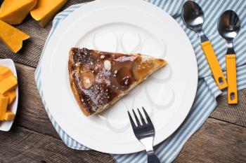 pieces of pie and cut pumpkin on table in Rustic style. Food photo