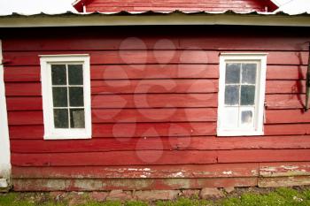 Wall and windows of the old red barn.