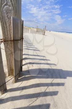 Sand dunes on Atlantic coast with a fence.