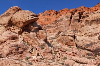 View of dry landscape and red rock formations of the Red Rock Canyon in the Mojave Desert.