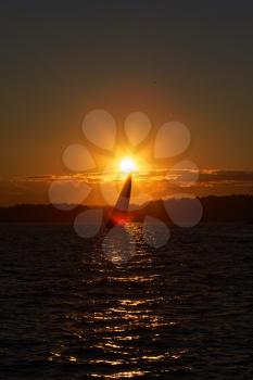 Sail boat at sunset on the ocean.