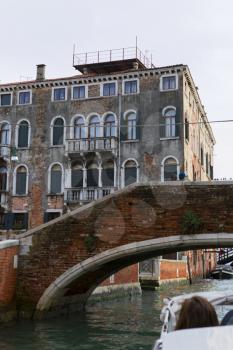 Venice, Italy - April 1, 2013: Street views of canals and ancient architecture in Venice, Italy. Venice is a city in northeastern Italy sited on a group of 118 small islands separated by canals and li