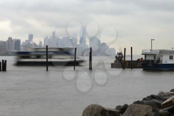 New York, USA-June 2, 2015: East River Ferry coming in for docking on a foggy day.