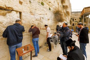 Jerusalem, Israel-March 14, 2017: The Western Wall is the holiest place where Jews are permitted to pray, though it is not the holiest site in the Jewish faith, which lies behind it, on Temple Mount.