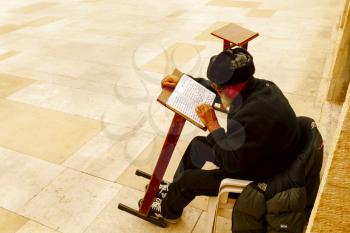 Jerusalem, Israel-March 14, 2017: Jews pray at The Western Wall - the holiest place where Jews are permitted to pray, though it is not the holiest site in the Jewish faith, which lies behind it, on Te