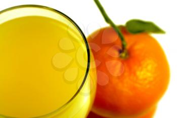 close-up of orange juice in glass and mandarin fruit