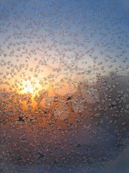 frosty natural pattern and sun on winter window