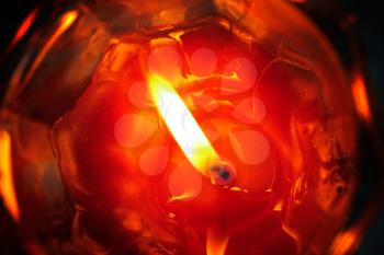 close-up of a burning candle in the dark