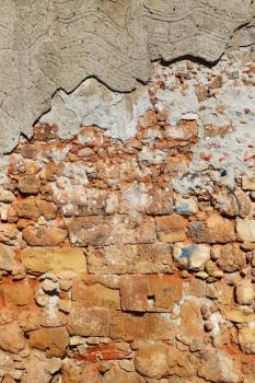 Very ancient destroyed brick wall with concrete, close-up texture