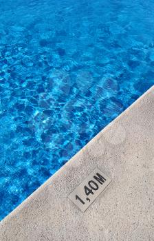 Background of swimming pool with marking depth on concrete border