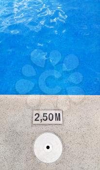 Background of swimming pool with marking depth on concrete border