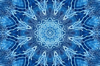 Blue background with concentric abstract pattern of soap foam on glass
