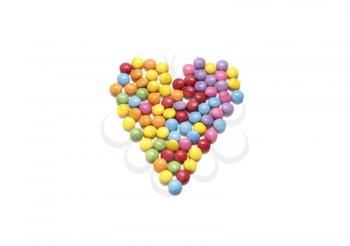 Abstract heart from colored chocolate candy in multicolored glaze isolated on white background