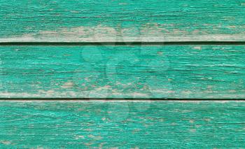 Texture of old wooden green fence close-up