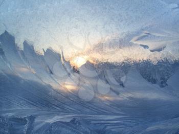 Beautiful ice pattern and sunlight on winter glass, natural closeup texture