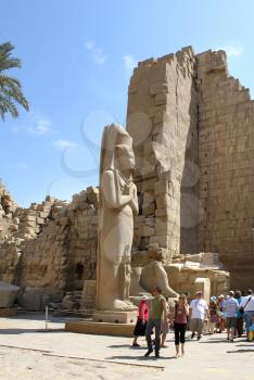 LUXOR / EGYPT - OCTOBER 13, 2012: Tourists among the ancient ruins of Karnak Temple