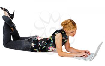 Royalty Free Photo of a Young Woman Laying on the Floor Using her Laptop