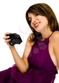 Royalty Free Photo of a Woman Sitting Down Holding a Camera