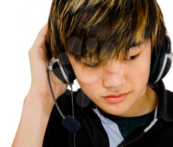 Royalty Free Photo of a Teenage Boy Listening to Music on Headphones