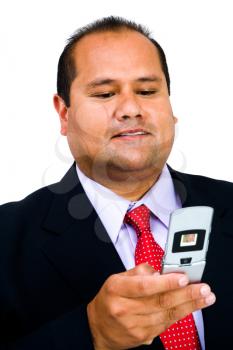 Royalty Free Photo of a Businessman Text Messaging on his Cellular Phone