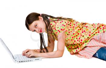 Royalty Free Photo of a Young Girl on the Floor Using a Laptop