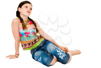 Royalty Free Photo of a Young Girl Sitting on the Floor Daydreaming