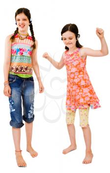 Royalty Free Photo of Young Girls Listening to Music on Headphones and Dancing