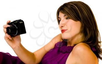 Happy woman photographing with a camera and smiling isolated over white