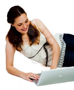 Smiling young woman using a laptop isolated over white