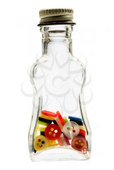 Assorted buttons in a bottle isolated over white