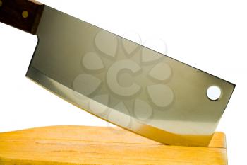 Close-up of a meat cleaver with a cutting board isolated over white