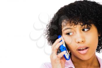 African teenage girl talking on a mobile phone isolated over white