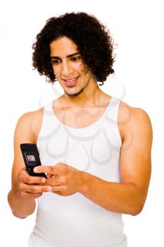 Young man text messaging on a mobile phone isolated over white