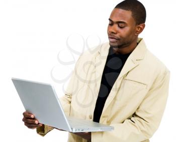 Young man using a laptop and posing isolated over white