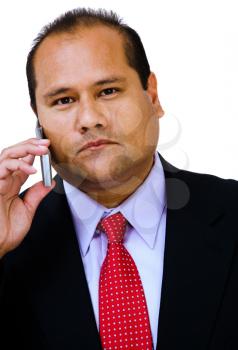 Mid adult businessman talking on a mobile phone isolated over white