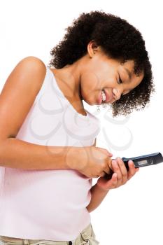 Girl using a mobile phone isolated over white