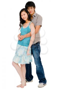 Young couple smiling and posing together isolated over white