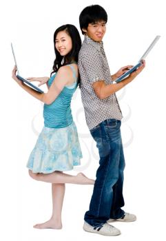 Man and woman using laptops and smiling isolated over white