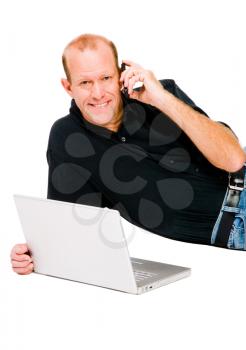 Caucasian man using a laptop and a mobile isolated over white