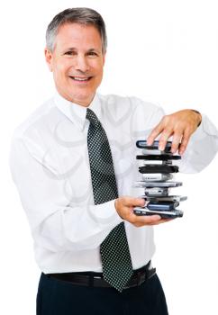Portrait of a businessman holding a stack of phones isolated over white