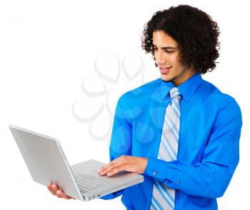 Man using a laptop and smiling isolated over white