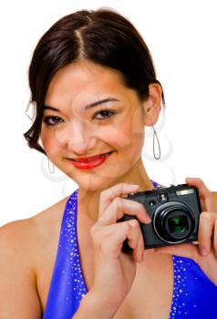 Mixedrace woman photographing with a camera and smiling isolated over white