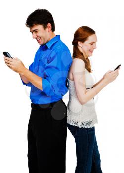 Young couple text messaging on mobile phones isolated over white