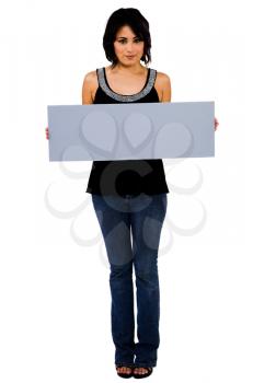 Latin American woman showing an empty placard isolated over white