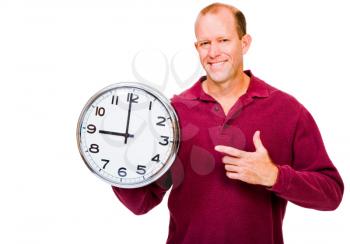 Caucasian man showing a clock and smiling isolated over white
