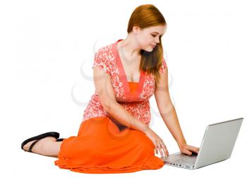 Young woman using a laptop isolated over white