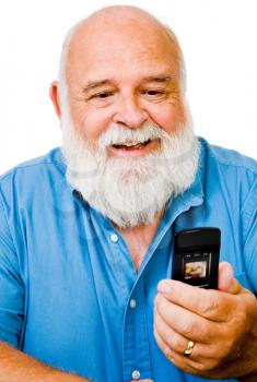 Confident man text messaging on a mobile phone isolated over white